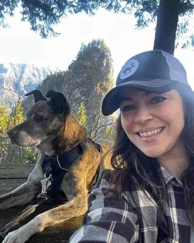 Julia Metz with dog in forest 