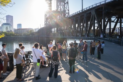 A group participates in the East Portland walk audit near Portland's Steel Bridge