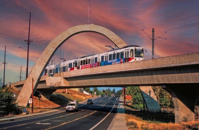 A max train passes under an archway in Hillsboro