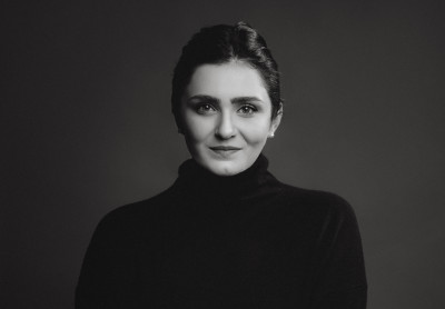Black and white photo of a woman in a black turtleneck