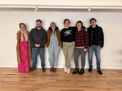 Six smiling people pose for the camera