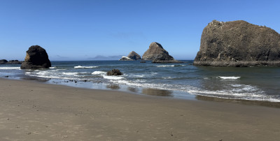 Offshore sea stacks amid calm, blue waters on a sunny day
