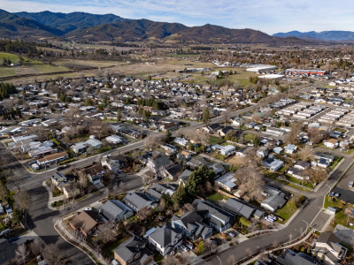 Aerial view of a small city surrounded by hills