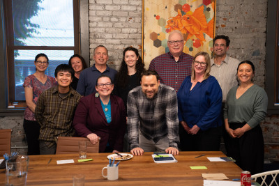 A smiling group of people in an indoor setting