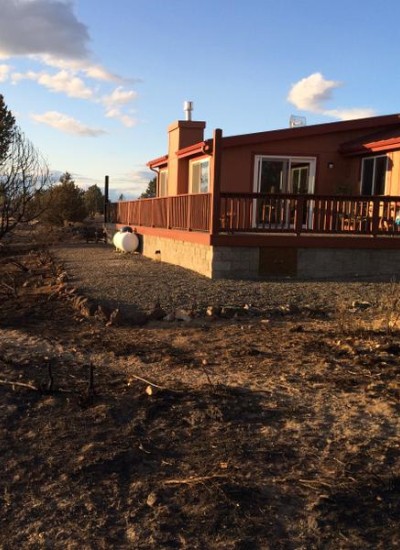 A photo of home shows clear defensible space with no obstructions around the structure