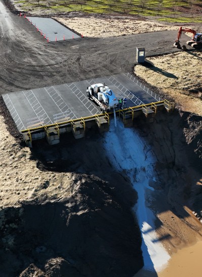 An aerial view of a truck dumping unknown liquid into the dump site on French Prairie farmland.