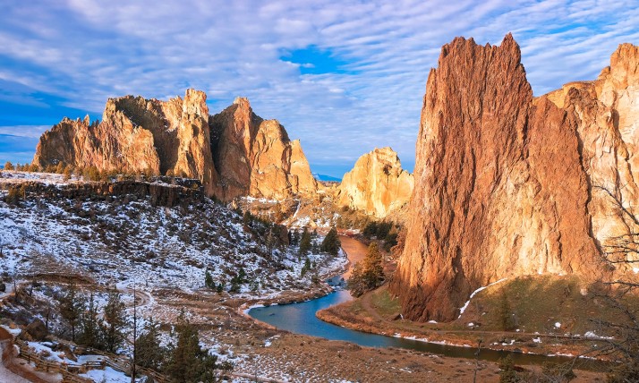 Smith Rock against bright blue sky with snow on the ground