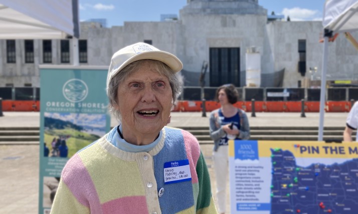 Nancie Peacocke Fadeley stands in front of the Oregon capitol building, smiling and looking to the side