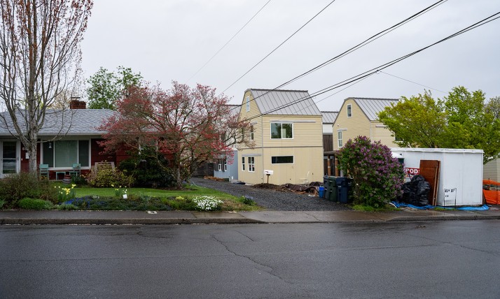 A view from the street of the Eugene cottage cluster shows how the construction tucks into the neighborhood