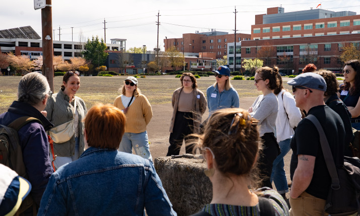 A group of people gathered in a circle near a housing development