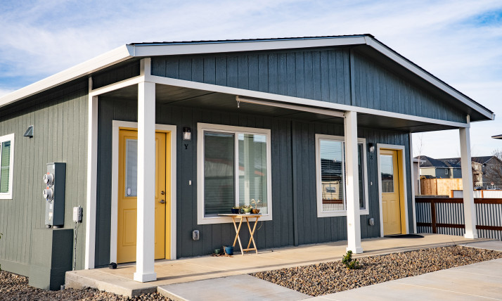 Duplex cottage with yellow doors and low, accessible ramps to the front doors (accessible senior housing in Talent, OR)