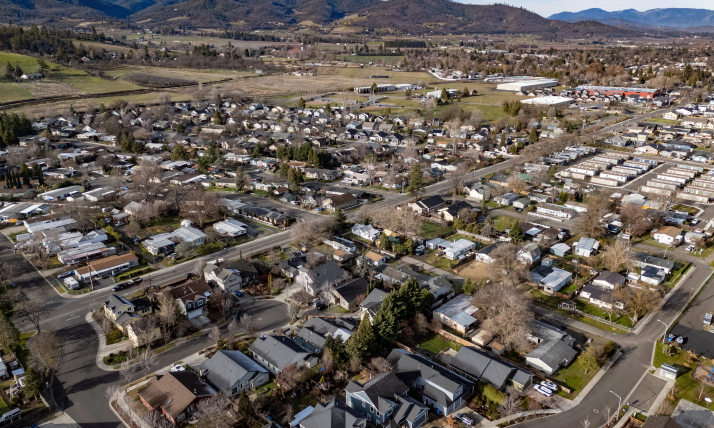 Aerial view of a small city surrounded by hills