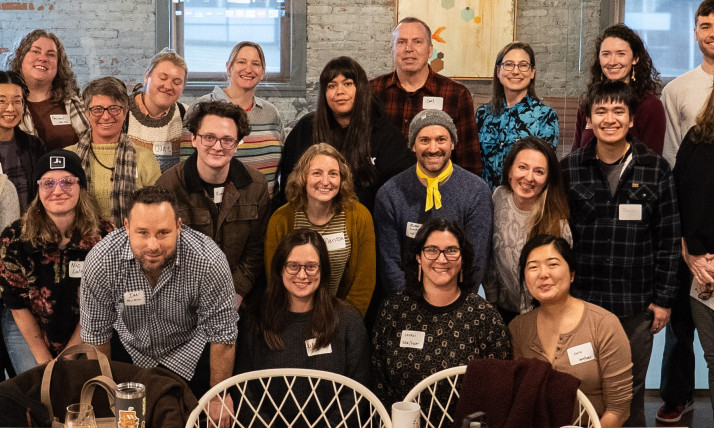 A group of smiling people in an indoor office space