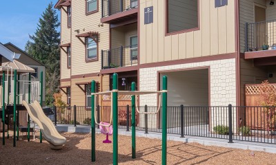 Multi-story housing surrounds a playground