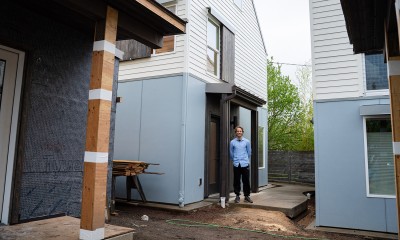 Jake Harder stands in a shared central area outside his home that's part of a cottage cluster