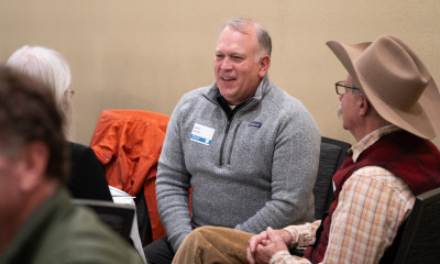 A group of people talking and smiling together