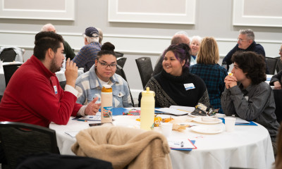 A group of people at a table, deep in discussion