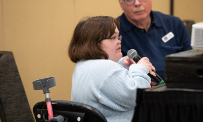 Cassie Wilson speaking into a microphone