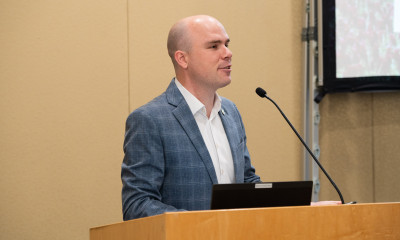 Rep. Ben Bowman speaking at a podium