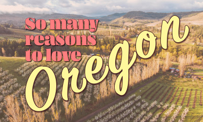 So many reasons to love Oregon, layered over a photo of rolling hills and rows of blooming orchards