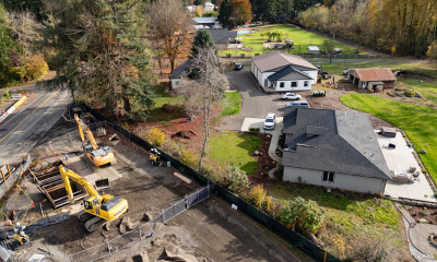 Aerial view of homes right next to heavy equipment and excavation