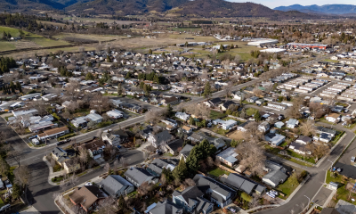Aerial view of a small city surrounded by hills