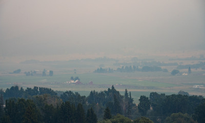 Aerial view of farmland blanketed in thick smoke
